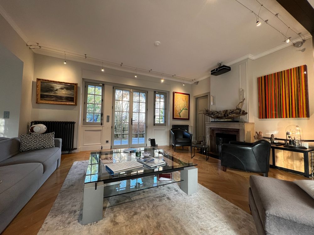 The living room with fireplace and French windows