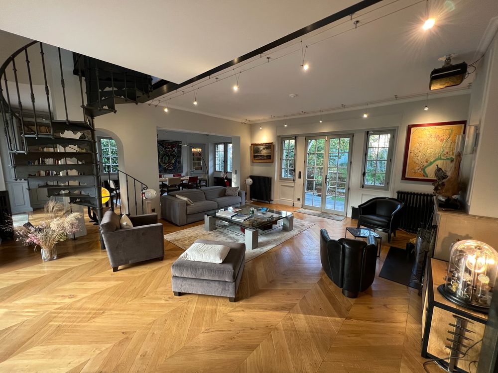 The double living room with its spiral staircase and herringbone oak floor